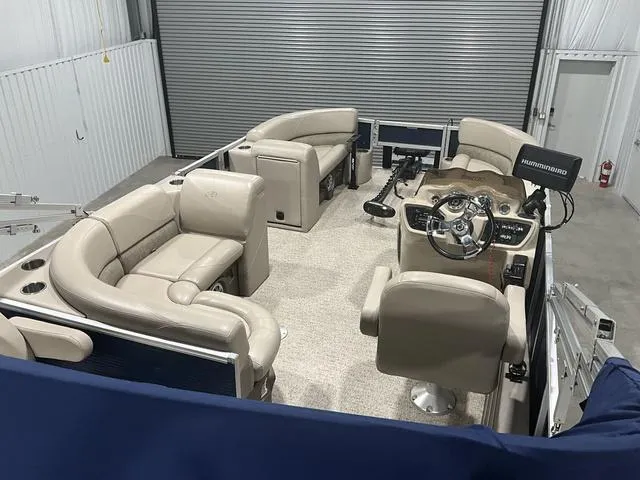 Slide: The Image of 2019 Avalon 22 LSZ pontoon boat interior with beige seating and steering console. - 14