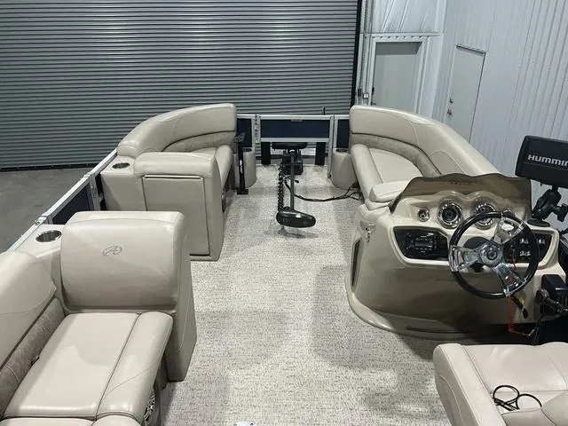 Slide: The Image of 2019 Avalon 22 LSZ pontoon boat interior with beige seating and steering console. - 8