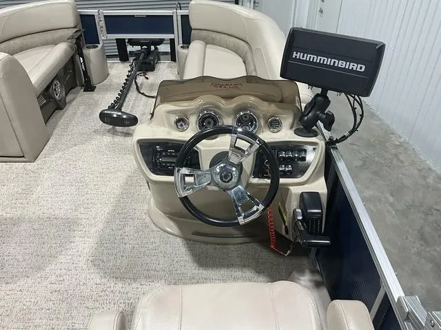 Slide: The Image of 2019 Avalon 22 LSZ boat interior with steering wheel and Humminbird fish finder. - 9