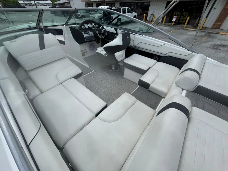 Slide: The Image of 2016 Regal 2100 RX Bowrider interior with white seating and modern dashboard. - 10