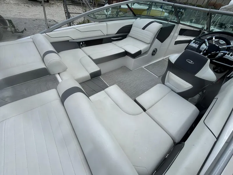Slide: The Image of 2016 Regal 2100 RX Bowrider interior with white seating and modern dashboard. - 13