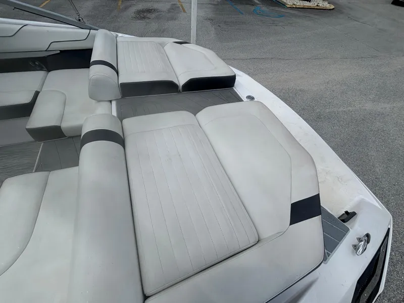 Slide: The Image of 2016 Regal 2100 RX Bowrider boat with spacious seating and sleek design. - 9