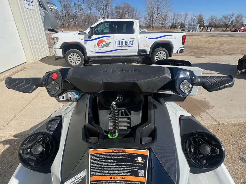 Slide: The Image of 2019 Sea-Doo Fish Pro 155 handlebars with control buttons, parked near a truck. - 10