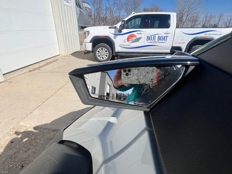 Slide: The Image of Reflection in Sea-Doo Fish Pro 155 mirror, with truck and building in background. - 15