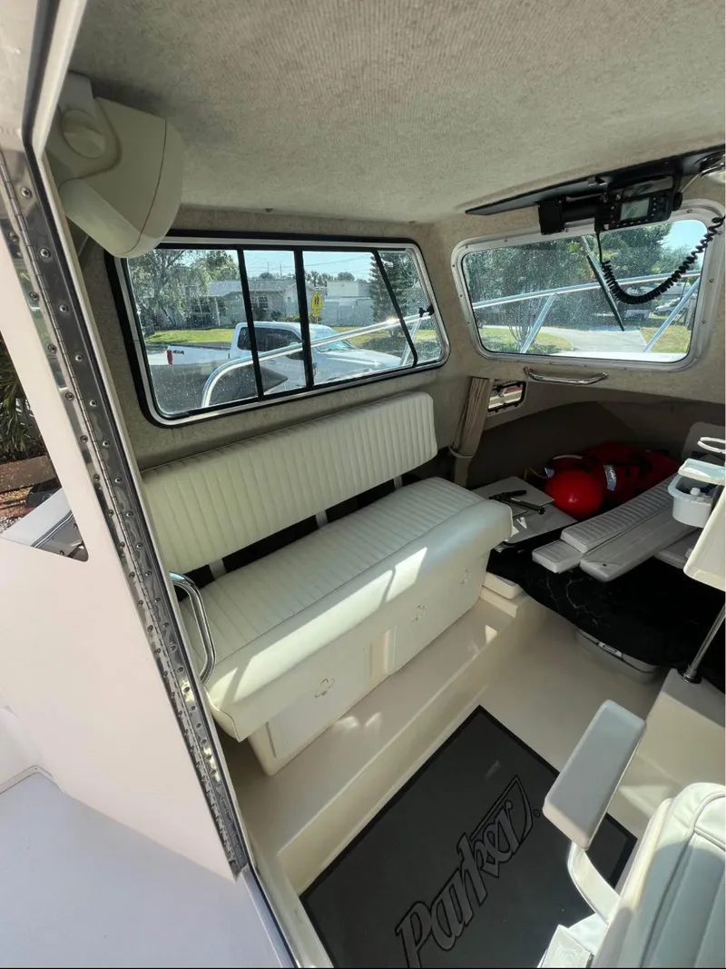 Slide: The Image of Interior of a 2008 Parker 2120 Sport Cabin boat with seating and windows. - 11