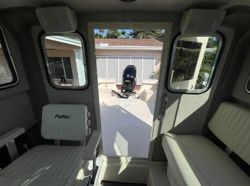 Slide: The Image of Interior view of 2008 Parker 2120 Sport Cabin boat with seating and outboard motor. - 12