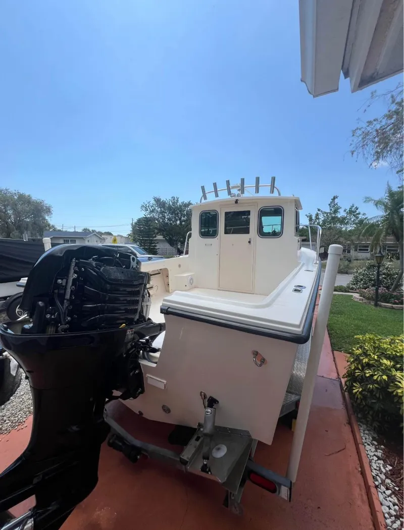Slide: The Image of 2008 Parker 2120 Sport Cabin boat with outboard motor on trailer. - 18