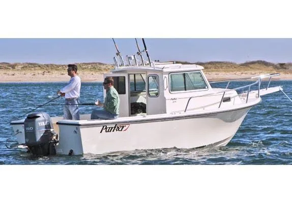 Slide: The Image of 2008 Parker 2120 Sport Cabin boat on water, two people fishing, Yamaha motor. - 20