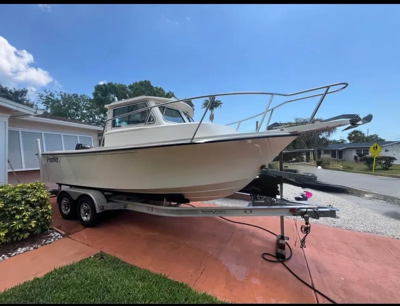 Slide: The Image of 2008 Parker 2120 Sport Cabin boat on trailer, parked in residential driveway. - 4