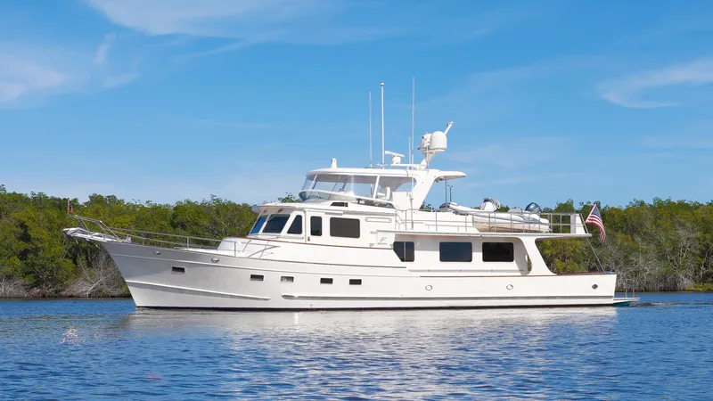 The Image of Luxury Fleming 65 yacht cruising on calm waters, 2023 model, under clear blue skies. - 0