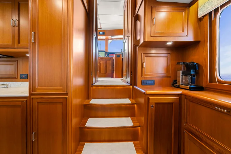 Slide: The Image of Luxurious wooden interior of 2023 Fleming 65 yacht with stairs and cabinetry. - 12