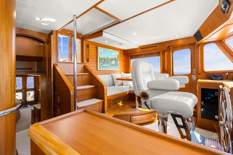 Slide: The Image of Luxurious interior of 2023 Fleming 65 yacht with elegant wood finishes and plush seating. - 13