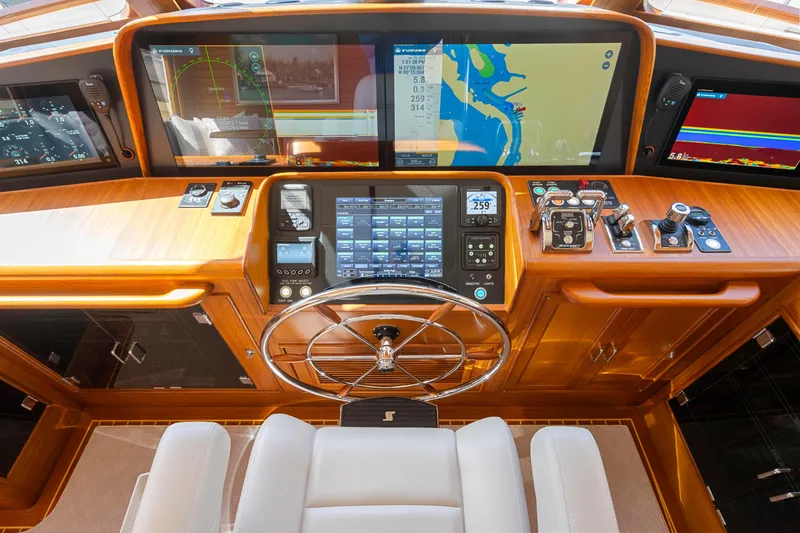 Slide: The Image of 2023 Fleming 65 yacht helm with advanced navigation displays and controls. - 15