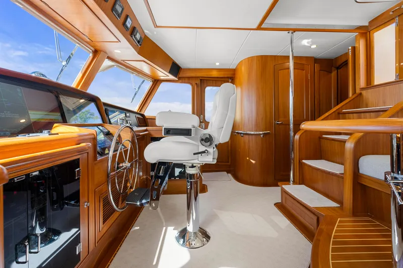 Slide: The Image of Luxurious 2023 Fleming 65 yacht interior with polished wood and modern helm station. - 16