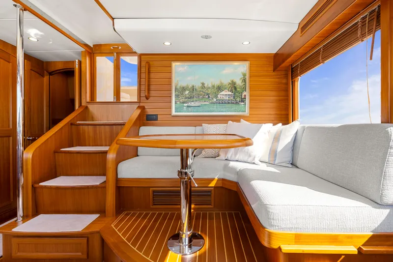 Slide: The Image of Luxurious interior of 2023 Fleming 65 yacht with elegant wood finish and cozy seating area. - 18