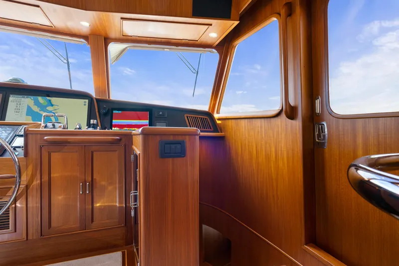 Slide: The Image of Interior of 2023 Fleming 65 yacht with wooden finish and navigation equipment. - 20