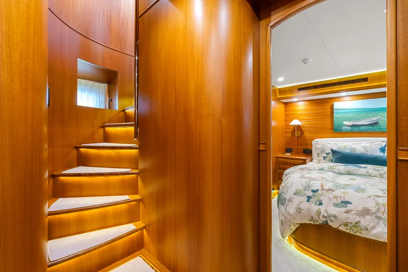 Slide: The Image of Luxurious interior of 2023 Fleming 65 yacht with wooden staircase and cozy bedroom. - 22