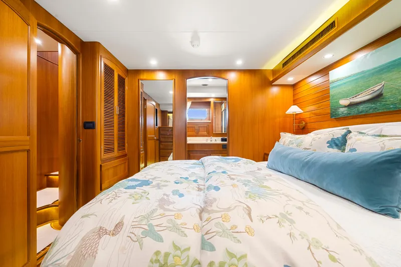 Slide: The Image of Luxurious bedroom in 2023 Fleming 65 yacht with wooden interiors and elegant bedding. - 24
