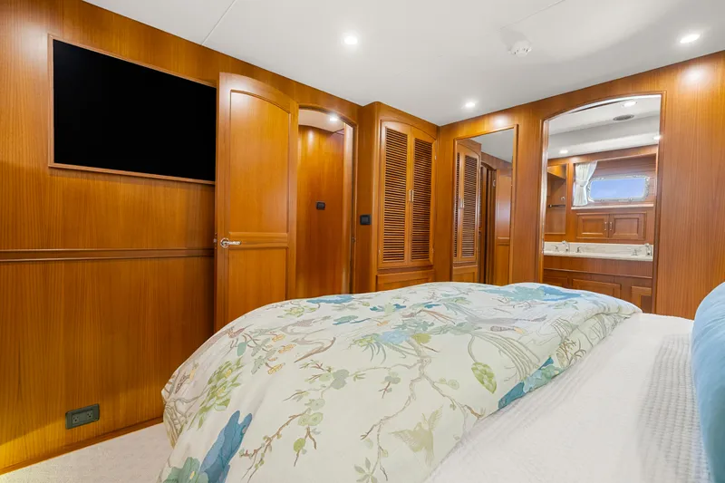 Slide: The Image of Luxurious bedroom interior of 2023 Fleming 65 yacht with wood paneling and modern amenities. - 27