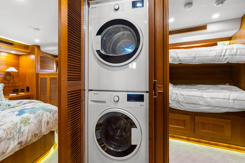 Slide: The Image of Stacked washer and dryer in luxurious 2023 Fleming 65 yacht cabin. - 29