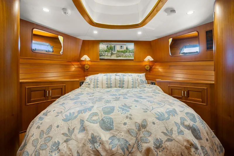 Slide: The Image of Luxurious cabin interior of 2023 Fleming 65 yacht with elegant wood paneling and cozy bedding. - 31