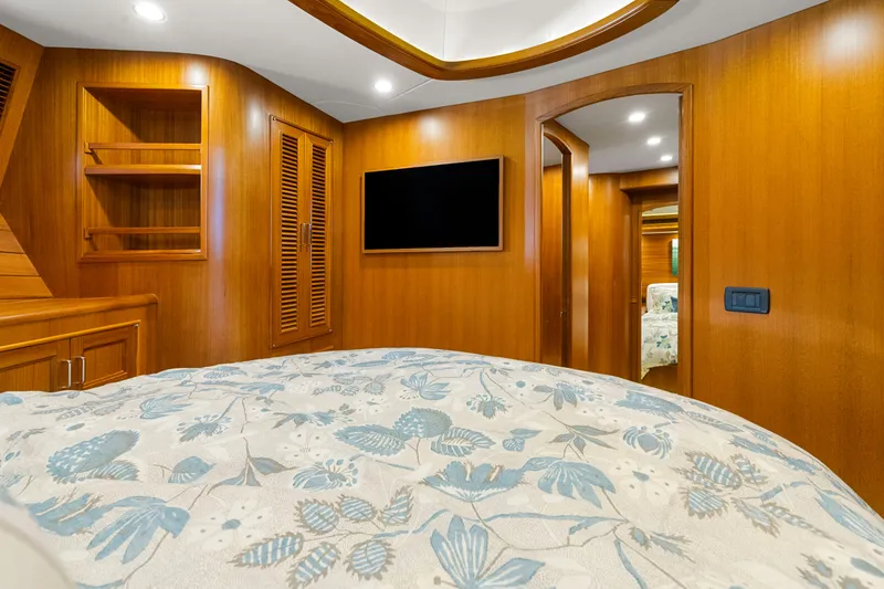 Slide: The Image of Luxurious cabin interior of 2023 Fleming 65 yacht with wood paneling and floral bedding. - 32