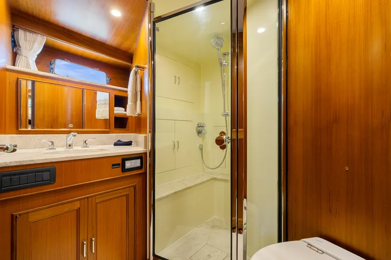 Slide: The Image of Luxurious bathroom in 2023 Fleming 65 yacht with wooden cabinetry and modern shower. - 33