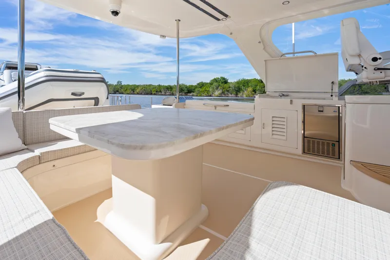 Slide: The Image of Luxurious 2023 Fleming 65 yacht interior with elegant seating and dining area. - 39