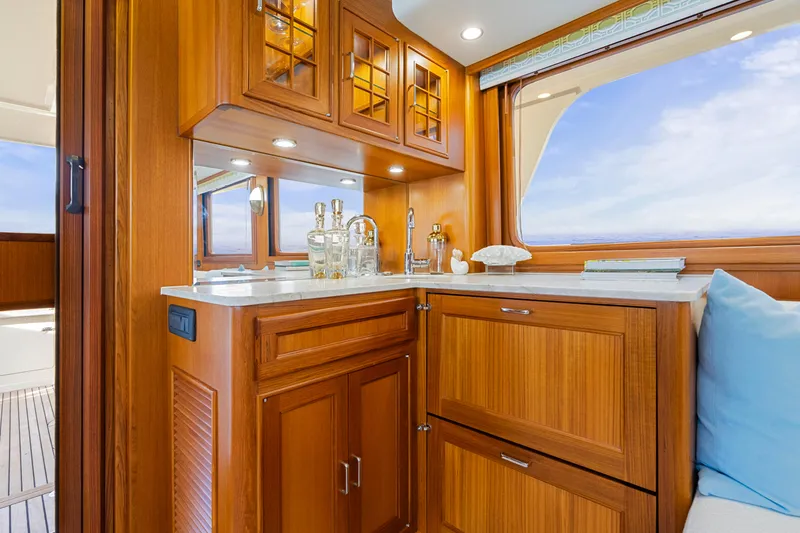 Slide: The Image of Luxurious wooden interior of 2023 Fleming 65 yacht with elegant cabinetry and ocean view. - 4