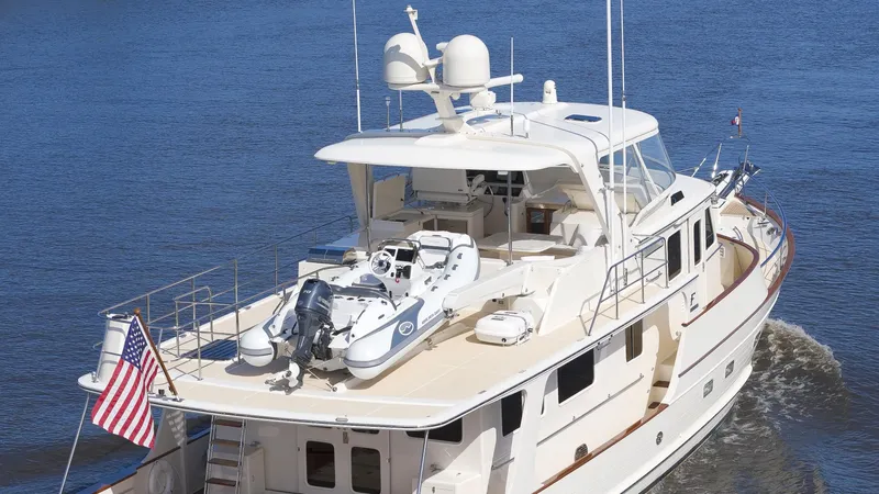 Slide: The Image of Luxury Fleming 65 yacht cruising on water, 2023 model, with American flag displayed. - 44