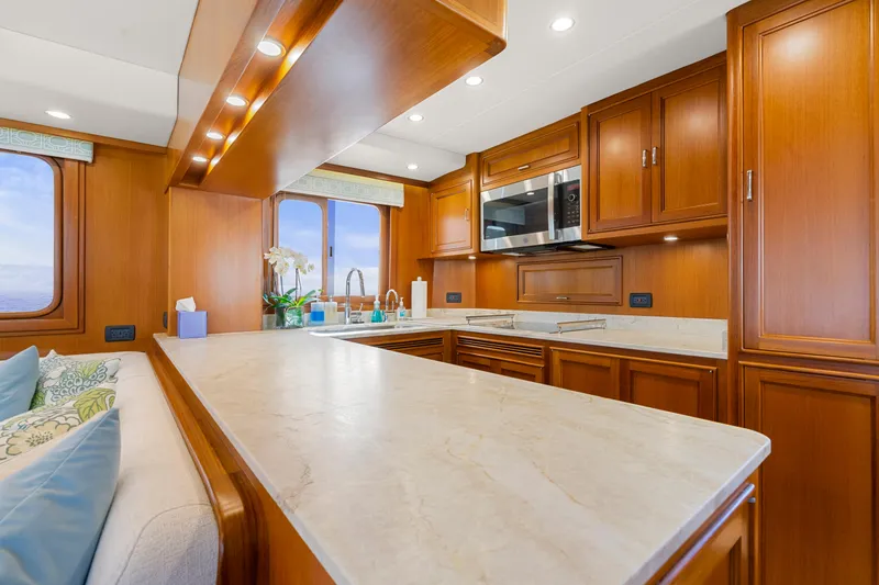 Slide: The Image of Luxurious kitchen interior of 2023 Fleming 65 yacht with wooden cabinetry and modern appliances. - 8