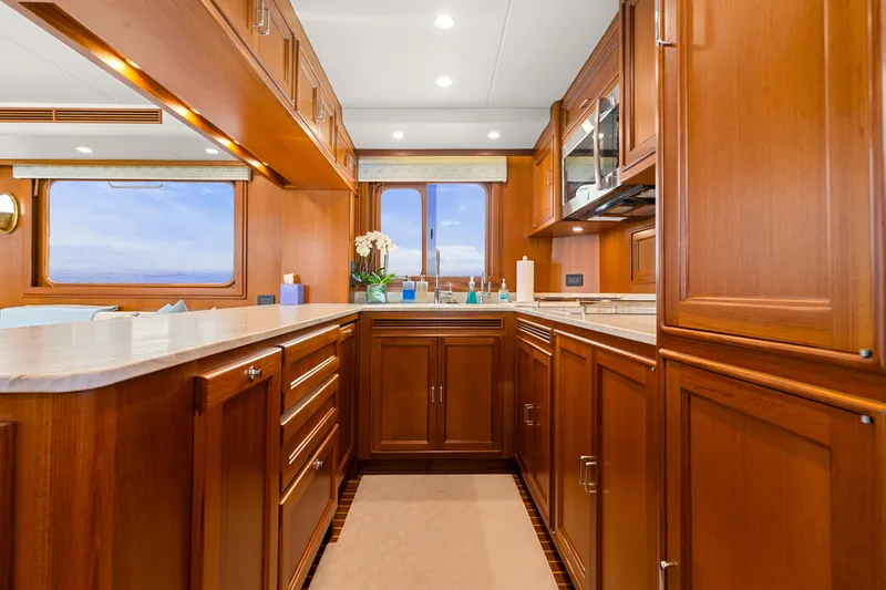 Slide: The Image of Luxurious kitchen interior of 2023 Fleming 65 yacht with wooden cabinetry and ocean view. - 9