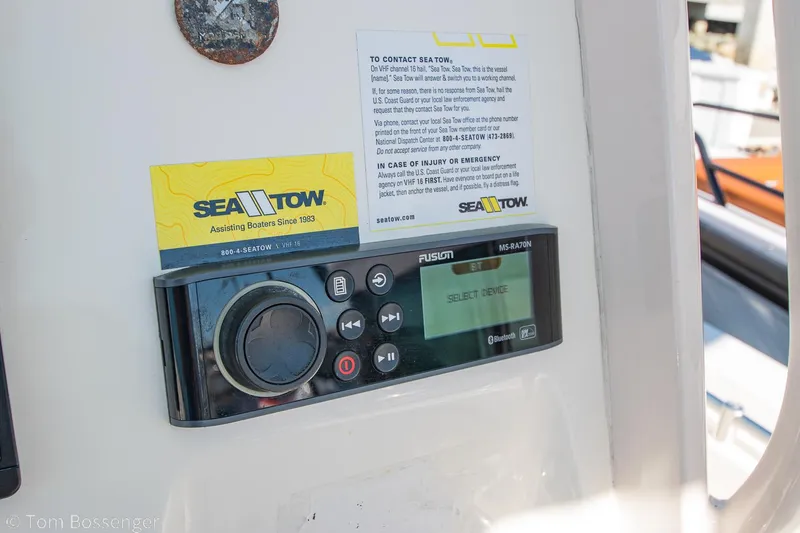 Slide: The Image of Fusion marine stereo on 2018 Cobia 240 CC boat dashboard with Sea Tow information. - 17