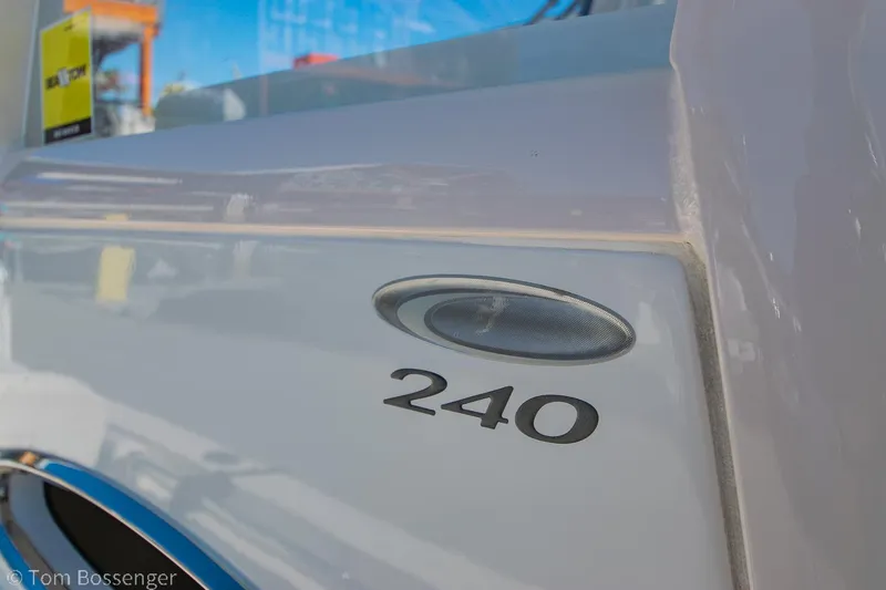 Slide: The Image of 2018 Cobia 240 CC boat detail with model number and sleek design. - 4