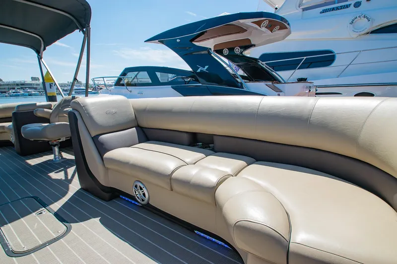 Slide: The Image of 2021 Manitou Oasis SHP pontoon boat with luxurious beige seating and modern design. - 40