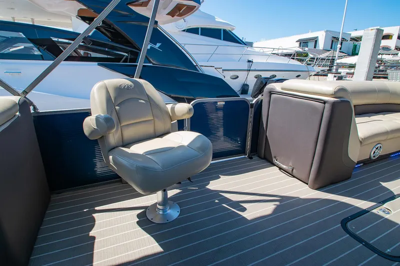 Slide: The Image of 2021 Manitou Oasis SHP pontoon boat interior with luxurious seating and modern design. - 47