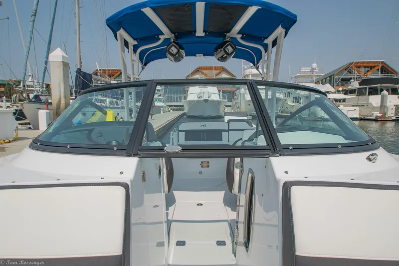 Slide: The Image of 2020 Monterey M4 boat docked at marina with blue canopy and clear windshield. - 15