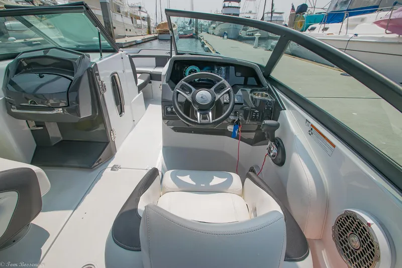 Slide: The Image of 2020 Monterey M4 boat cockpit with steering wheel and seating at marina. - 16