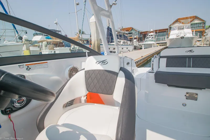 Slide: The Image of 2020 Monterey M4 boat interior at marina, featuring sleek seating and modern design. - 22