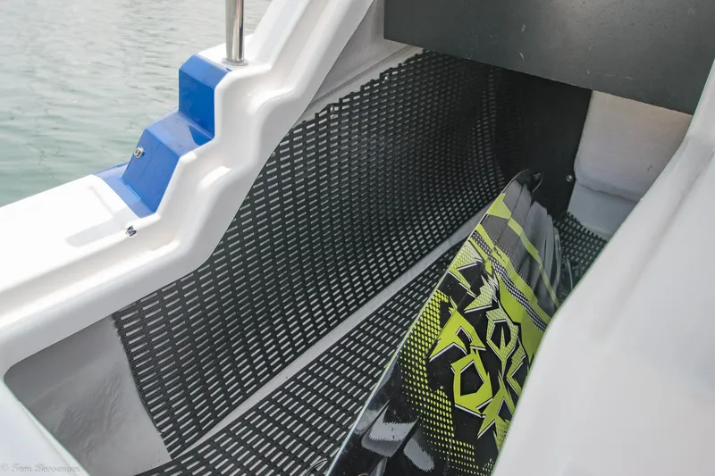 Slide: The Image of 2020 Monterey M4 boat interior with wakeboard storage area, featuring textured flooring and blue accents. - 26