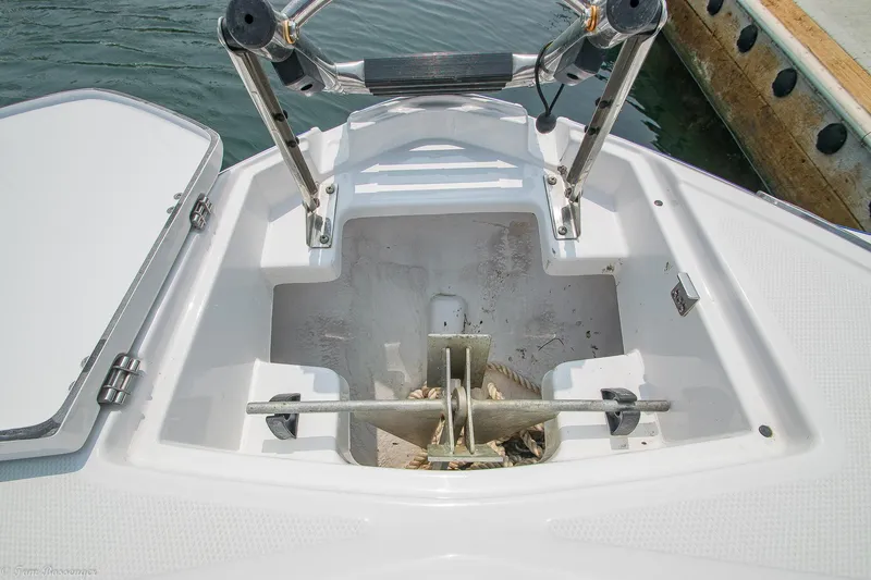 Slide: The Image of Anchor storage compartment on a 2020 Monterey M4 boat, open at the dock. - 27