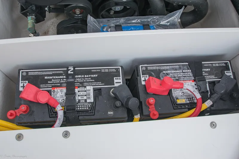 Slide: The Image of 2020 Monterey M4 boat batteries with red and black terminals in engine compartment. - 32