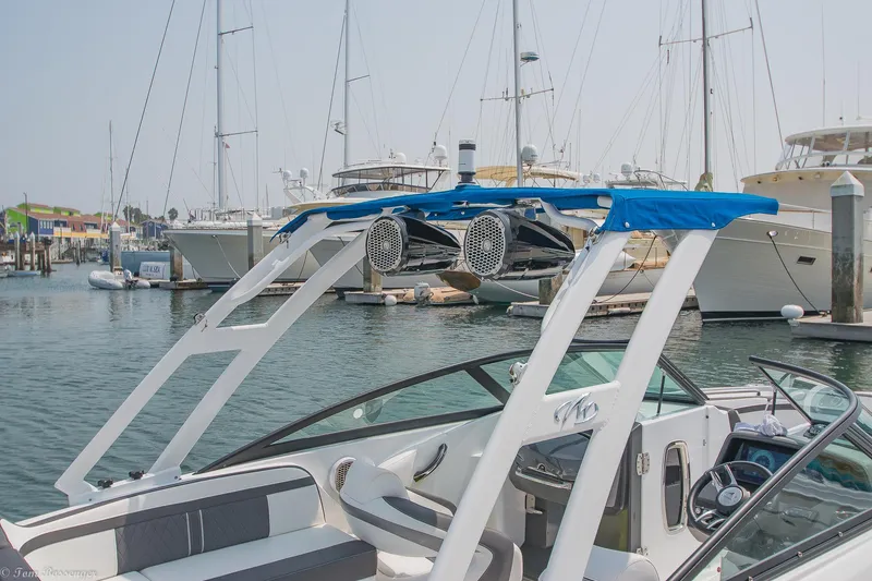 Slide: The Image of 2020 Monterey M4 boat docked in marina with sailboats in background. - 35