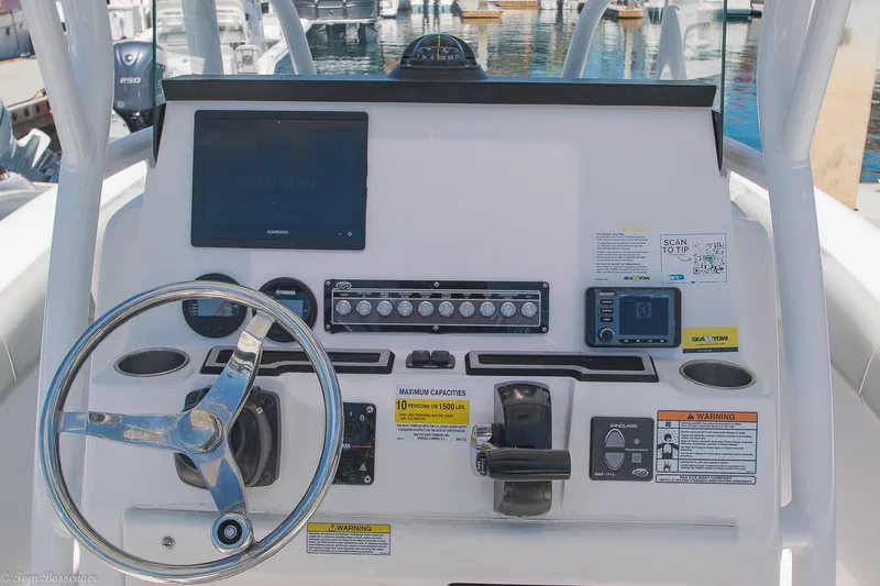 Slide: The Image of 2021 Sea Fox 248 Commander boat dashboard with steering wheel and electronic controls. - 10