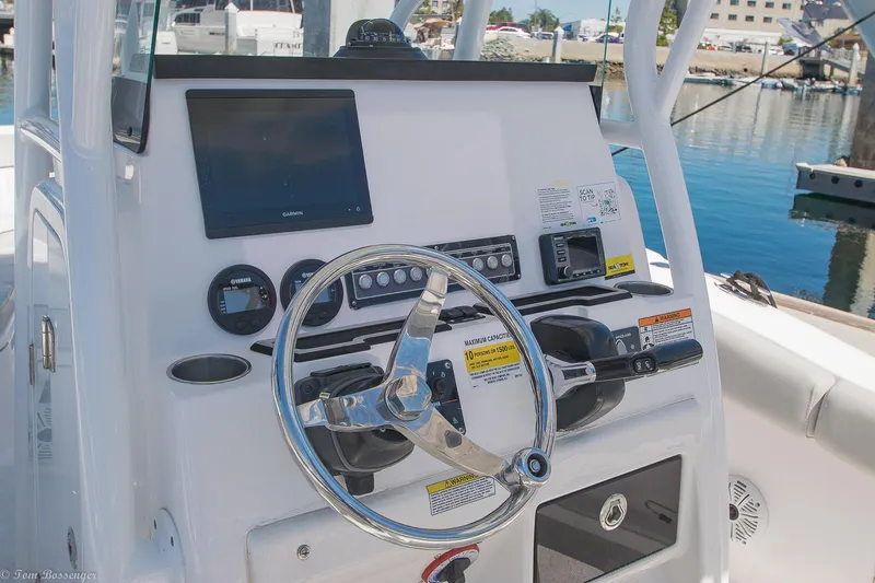 Slide: The Image of 2021 Sea Fox 248 Commander boat dashboard with steering wheel and navigation controls. - 11