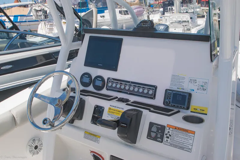 Slide: The Image of 2021 Sea Fox 248 Commander boat dashboard with steering wheel and electronic controls. - 12