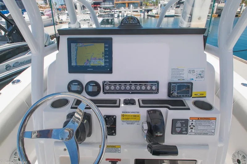 Slide: The Image of 2021 Sea Fox 248 Commander dashboard with navigation system and controls at marina. - 15