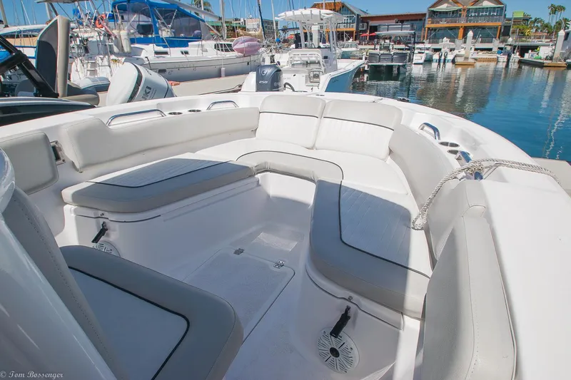 Slide: The Image of 2021 Sea Fox 248 Commander boat interior with cushioned seating in a marina. - 18