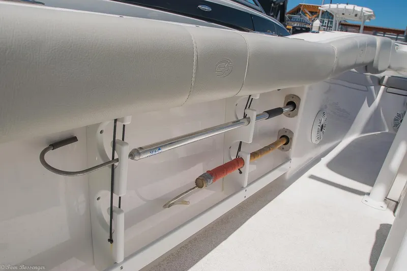 Slide: The Image of 2021 Sea Fox 248 Commander boat interior with fishing rod holders and cushioned seating. - 25