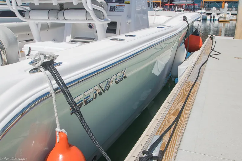 Slide: The Image of 2021 Sea Fox 248 Commander boat docked with visible logo and orange fenders. - 29